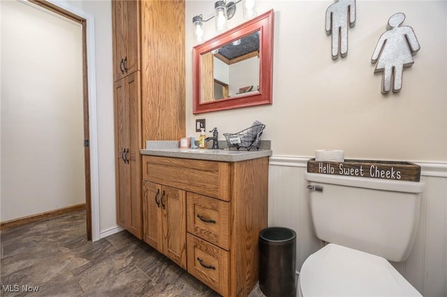 1902 26th Ave, Parkersburg, WV 26101 - bathroom featuring vanity, stone finish floors, and a wainscoted wall
