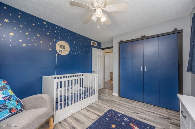 1902 26th Ave, Parkersburg, WV 26101 - bedroom with wood finished floors, a textured ceiling, and ceiling fan