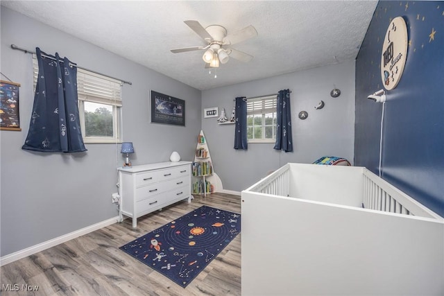 1902 26th Ave, Parkersburg, WV 26101 - bedroom with wood finished floors, a textured ceiling, and a ceiling fan