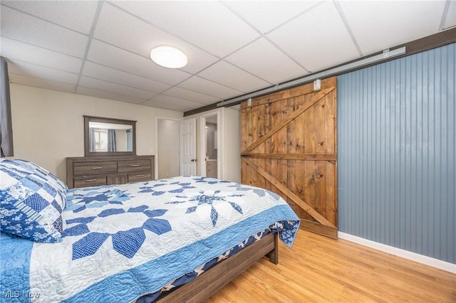 1902 26th Ave, Parkersburg, WV 26101 - bedroom featuring wood finished floors, a paneled ceiling, and a barn door