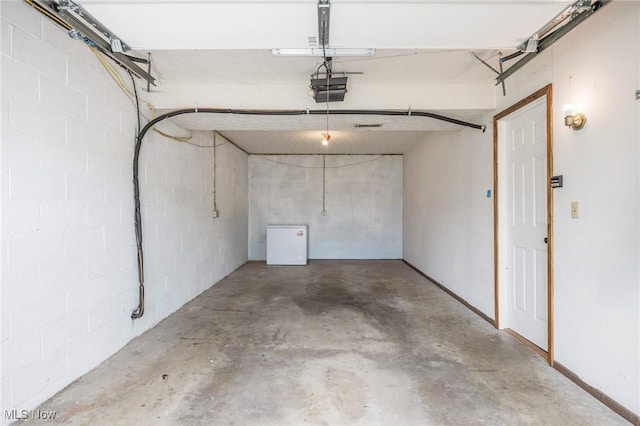 1902 26th Ave, Parkersburg, WV 26101 - garage featuring concrete block wall and a garage door opener