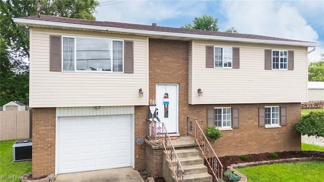 1902 26th Ave, Parkersburg, WV 26101 - bi-level home featuring brick siding, a garage, and concrete driveway