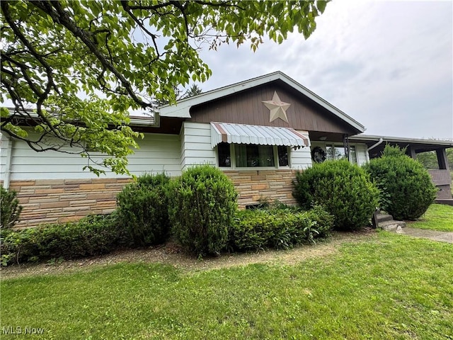 1281 Township Road 129, Adena, OH 43901 - view of front of house featuring stone siding and a front lawn