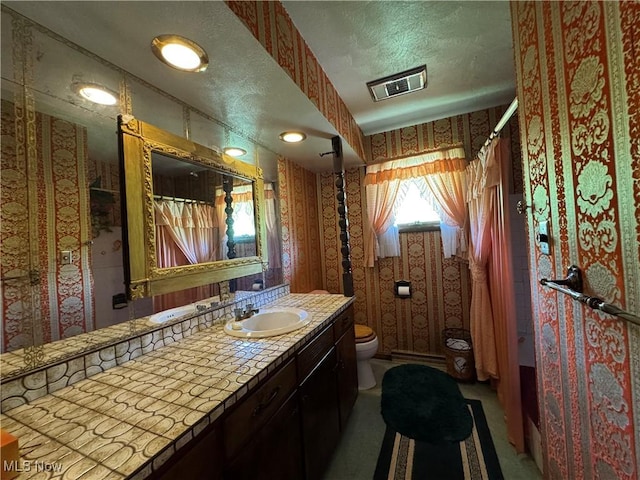 1281 Township Road 129, Adena, OH 43901 - bathroom featuring wallpapered walls, vanity, a shower with shower curtain, and a textured ceiling