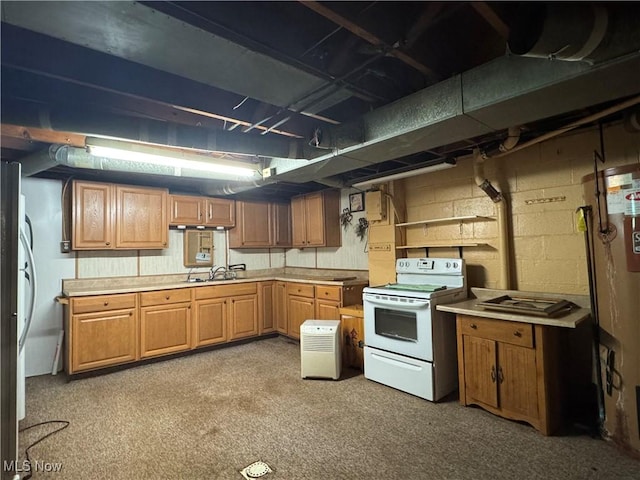 1281 Township Road 129, Adena, OH 43901 - kitchen with electric stove, light countertops, freestanding refrigerator, and concrete block wall