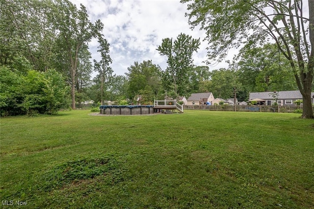 4050 Walter Rd, North Olmsted, OH 44070 - view of yard with a covered pool and view of wooded area