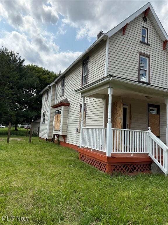 1225 Shorb Ave NW, Canton, OH 44703 - view of home's exterior featuring a porch, a yard, and a chimney