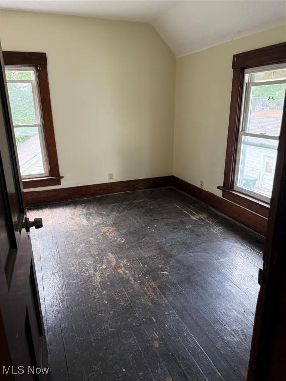 1225 Shorb Ave NW, Canton, OH 44703 - unfurnished room featuring hardwood / wood-style flooring, lofted ceiling, and healthy amount of natural light