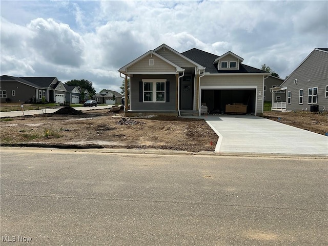 8928 Camden Rd NW, Massillon, OH 44646 - view of front of home featuring an attached garage, concrete driveway, and a residential view
