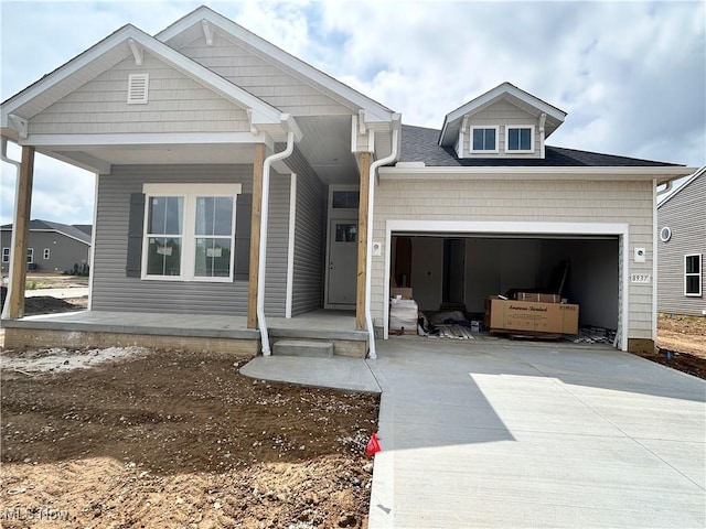 8928 Camden Rd NW, Massillon, OH 44646 - view of front of property featuring driveway, a garage, and a porch