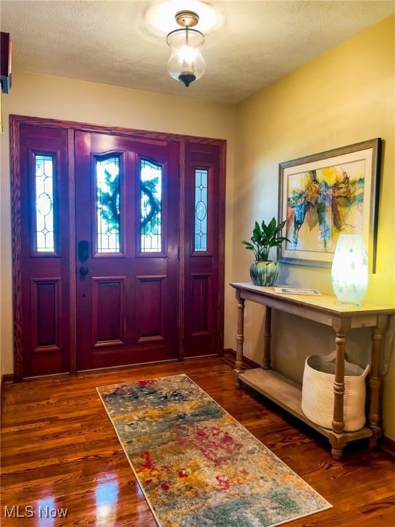 5507 13th Ave, Vienna, WV 26105 - entryway featuring dark wood finished floors, plenty of natural light, and a textured ceiling