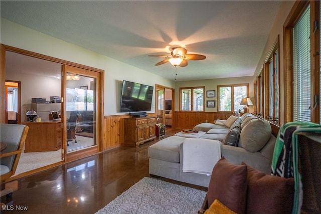5507 13th Ave, Vienna, WV 26105 - living room with a wainscoted wall, a ceiling fan, and wooden walls