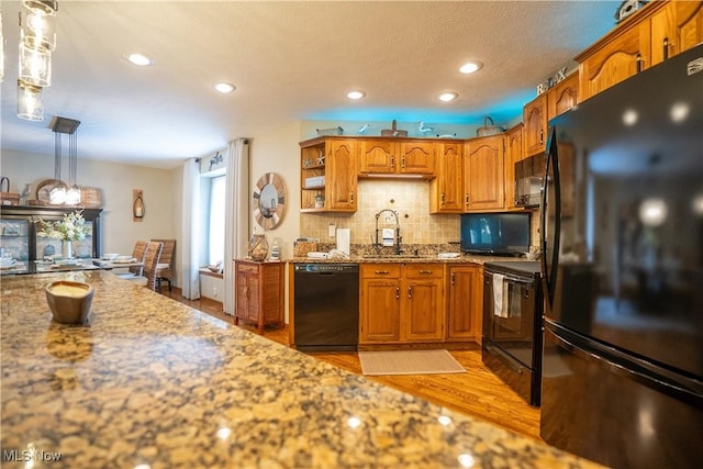 5507 13th Ave, Vienna, WV 26105 - kitchen with black appliances, light wood finished floors, tasteful backsplash, brown cabinetry, and recessed lighting
