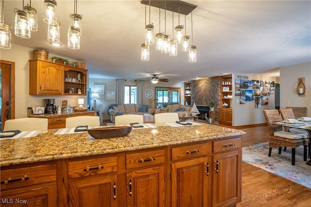 5507 13th Ave, Vienna, WV 26105 - kitchen with open floor plan, brown cabinetry, ceiling fan, light wood-type flooring, and open shelves