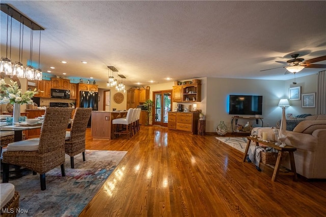 5507 13th Ave, Vienna, WV 26105 - dining room featuring wood finished floors, a textured ceiling, a ceiling fan, a chandelier, and recessed lighting