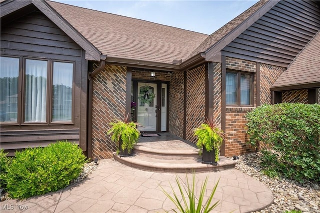 5507 13th Ave, Vienna, WV 26105 - view of exterior entry featuring brick siding and a shingled roof