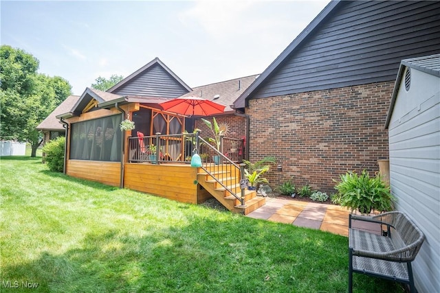 5507 13th Ave, Vienna, WV 26105 - rear view of house with a yard, a sunroom, brick siding, stairway, and a deck