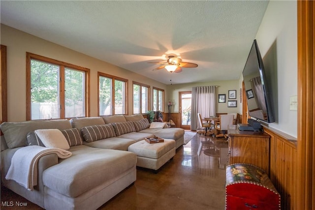 5507 13th Ave, Vienna, WV 26105 - living area with healthy amount of natural light, ceiling fan, wainscoting, and a textured ceiling