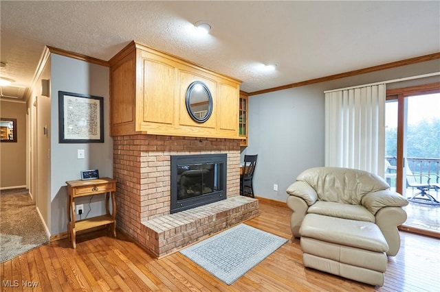 3145 Franks Rd, Clinton, OH 44216 - living area featuring ornamental molding, light wood finished floors, a brick fireplace, and attic access