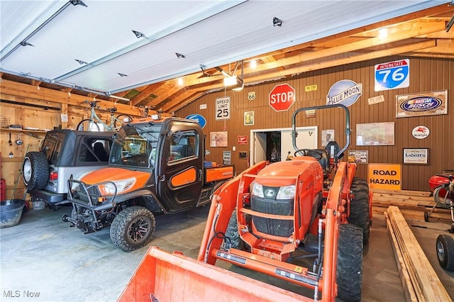 3145 Franks Rd, Clinton, OH 44216 - garage with wood walls and a garage door opener