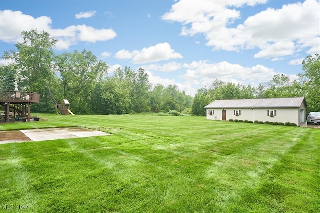 3145 Franks Rd, Clinton, OH 44216 - view of grassy yard featuring a playground and a deck