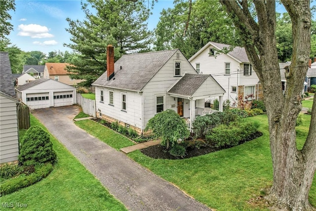 341 Kenmore Ave NE, Warren, OH 44483 - view of front facade featuring a garage, a chimney, an outbuilding, and a front yard