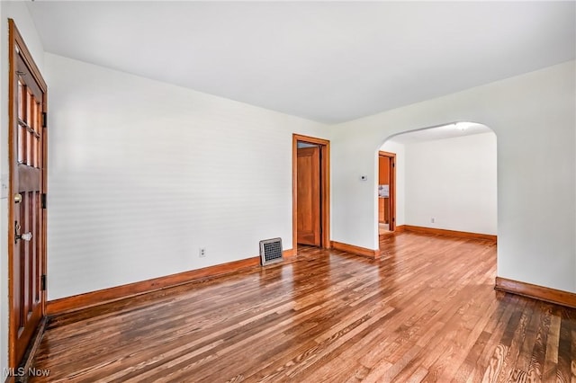 341 Kenmore Ave NE, Warren, OH 44483 - empty room with wood finished floors and arched walkways