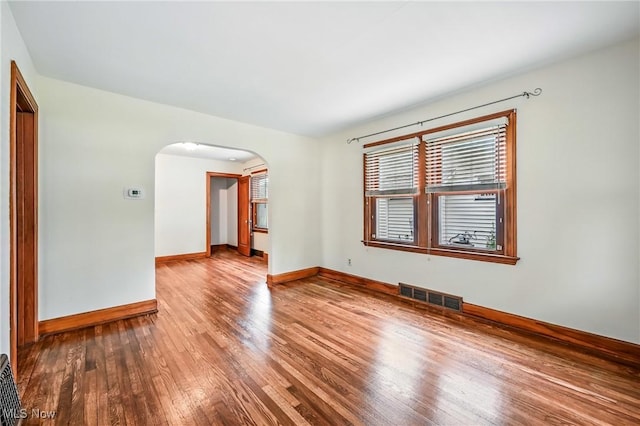 341 Kenmore Ave NE, Warren, OH 44483 - unfurnished room featuring arched walkways and wood-type flooring