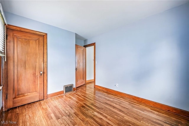 341 Kenmore Ave NE, Warren, OH 44483 - unfurnished bedroom featuring baseboards and wood finished floors