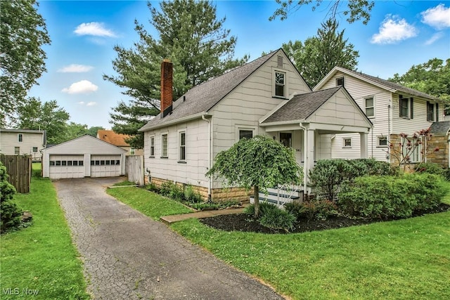 341 Kenmore Ave NE, Warren, OH 44483 - bungalow-style home with an outdoor structure, a detached garage, a chimney, and roof with shingles