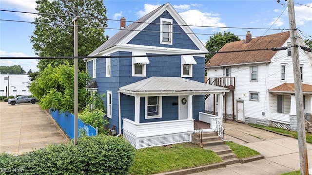 275 Fountain St, Akron, OH 44306 - american foursquare style home featuring a porch and roof with shingles