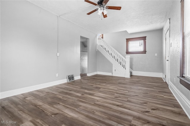 275 Fountain St, Akron, OH 44306 - unfurnished living room featuring stairway, ceiling fan, wood finished floors, and a textured ceiling