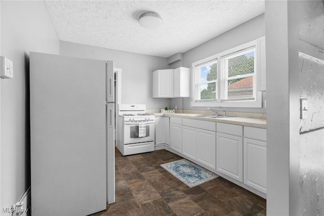 275 Fountain St, Akron, OH 44306 - kitchen with white appliances, a textured ceiling, white cabinets, and light countertops