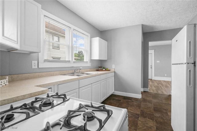 275 Fountain St, Akron, OH 44306 - kitchen with white appliances, light countertops, white cabinets, and a textured ceiling