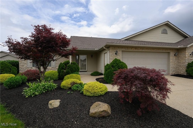 1011 Sequoia Dr NW, Strasburg, OH 44680 - view of front of house with stone siding, a shingled roof, and a garage