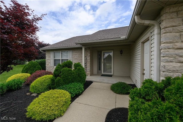 1011 Sequoia Dr NW, Strasburg, OH 44680 - view of exterior entry with stone siding and a shingled roof