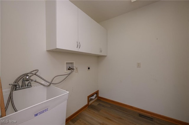 1011 Sequoia Dr NW, Strasburg, OH 44680 - washroom with electric dryer hookup, cabinet space, wood finished floors, and hookup for a washing machine