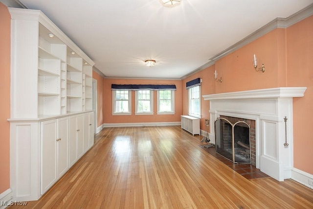 2611 Exeter Rd, Cleveland Heights, OH 44118 - unfurnished living room with healthy amount of natural light, light wood-style flooring, a fireplace with flush hearth, and ornamental molding
