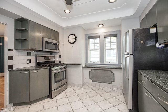 2611 Exeter Rd, Cleveland Heights, OH 44118 - kitchen featuring stainless steel appliances, a tray ceiling, open shelves, backsplash, and light tile patterned floors