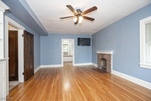 2611 Exeter Rd, Cleveland Heights, OH 44118 - unfurnished living room featuring wood-type flooring, a ceiling fan, a fireplace, and cooling unit