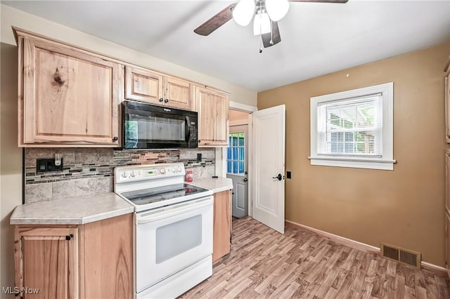 6406 State Route 45, Bristolville, OH 44402 - kitchen featuring black microwave, electric stove, light brown cabinetry, decorative backsplash, and light countertops