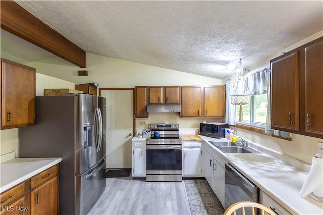 733 Lake Erie St, Conneaut, OH 44030 - kitchen featuring stainless steel appliances, under cabinet range hood, a textured ceiling, light wood-style floors, and light countertops