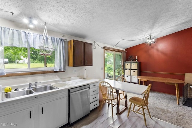 733 Lake Erie St, Conneaut, OH 44030 - kitchen with stainless steel dishwasher, a textured ceiling, light countertops, and light wood-type flooring