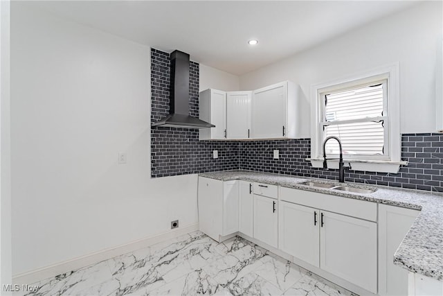 3414 Virginia Ave, Cleveland, OH 44109 - kitchen with wall chimney range hood, white cabinetry, decorative backsplash, light stone counters, and light marble finish floors