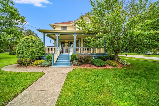 98 W Walnut St, Jefferson, OH 44047 - victorian home featuring covered porch, a front yard, and stairway