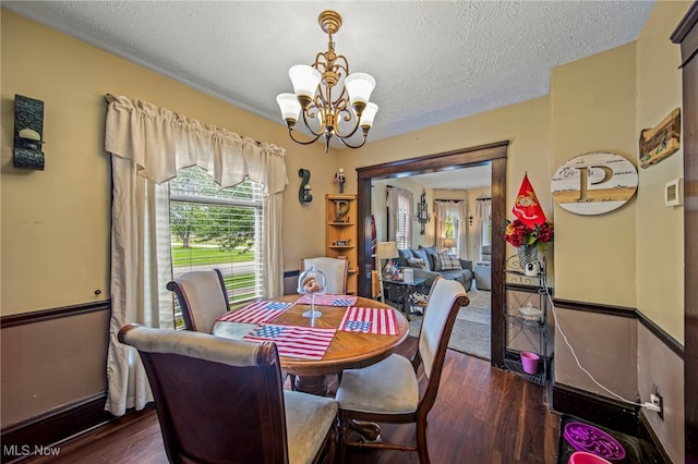 98 W Walnut St, Jefferson, OH 44047 - dining area featuring a chandelier, wood finished floors, and a textured ceiling
