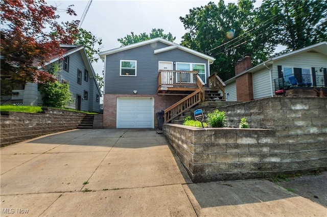 1399 Neptune Ave, Akron, OH 44301 - view of front facade with stairs, brick siding, driveway, and a garage