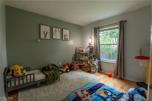 1399 Neptune Ave, Akron, OH 44301 - bedroom with multiple windows and hardwood / wood-style flooring