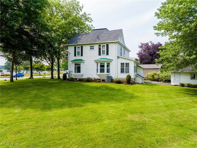 1237 Center St, Ashland, OH 44805 - back of house with a lawn and a shingled roof