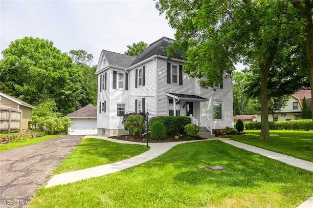 1237 Center St, Ashland, OH 44805 - traditional style home with a detached garage, a front lawn, and a shingled roof